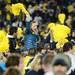 Michigan fans celebrate after leaving the stands and crowding the field at Michigan Stadium on Saturday. Melanie Maxwell I AnnArbor.com